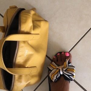 I am selling a sandal with a multi colored bow.